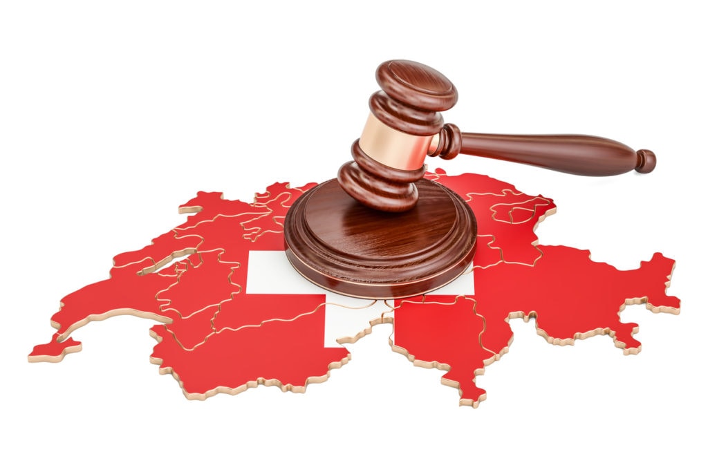 Wooden Gavel on map of Switzerland, 3D rendering isolated on white background
